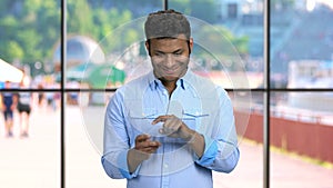 Smiling man using application on glass digital tablet.