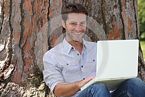 Smiling man using laptop