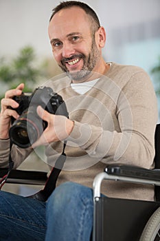 smiling man using mirrorless camera