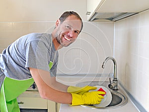 Smiling man washing dish