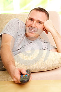 Smiling man watching television