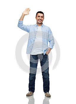 Smiling man waving hand