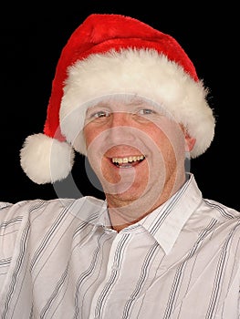 Smiling man wearing Santa hat