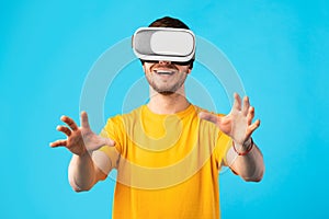 Smiling man wearing virtual reality headset at the studio