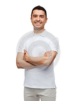 Smiling man in white t-shirt with crossed arms