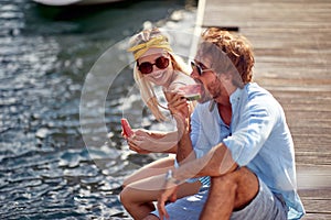 Smiling  man and woman enjoying together at holiday .and eating watermalon