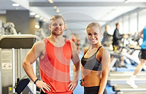 Smiling man and woman in gym