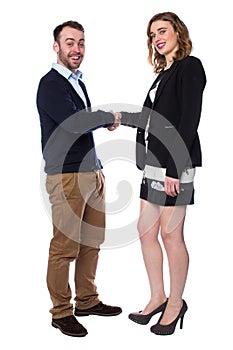 Smiling man and woman shaking hands on a deal