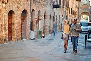 Smiling man and woman travelling in European