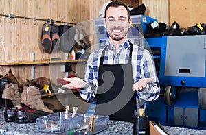 Smiling man worker displaying his workplace