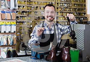 Smiling man worker displaying result of his key