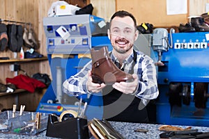 Smiling man worker displaying result of his work