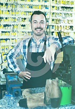 Smiling man worker preparing his tools for repairing