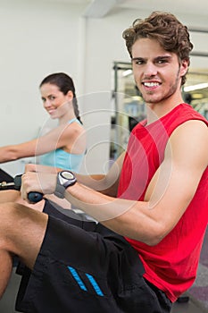 Smiling man working out on the rowing machine