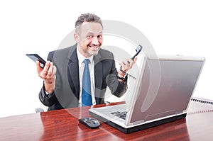 Smiling manager holding smartphone and receiver