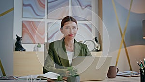 Smiling manager resting armchair modern interior closeup. Woman looking camera