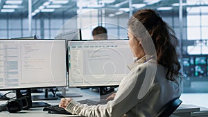 Smiling manager in server hub using computer to find firewall misconfigurations