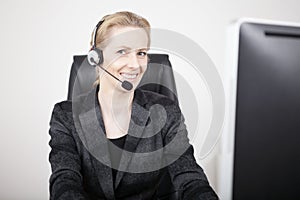 Smiling Manageress Wearing Headset at her Office