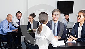 Smiling managers with laptops having a productive day