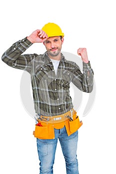 Smiling manual worker clenching fist