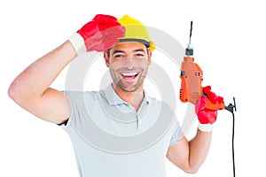 Smiling manual worker holding drill machine