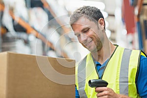 Smiling manual worker scanning package