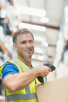 Smiling manual worker scanning package