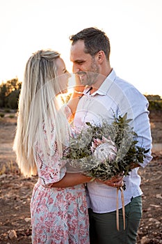 Smiling married couple in a mediterranean location at sunset