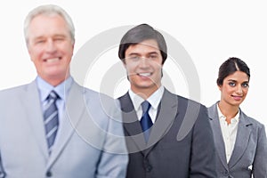 Smiling mature businessman with his employees