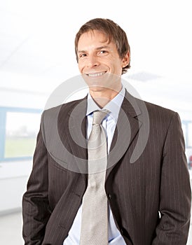 Smiling mature businessman in office environment