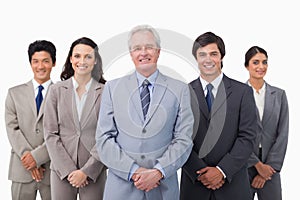 Smiling mature businessman standing with his team