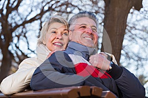 Smiling mature couple relaxing in park