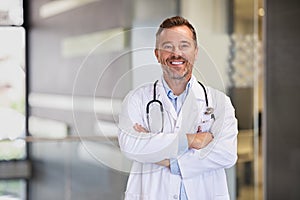 Smiling mature doctor in hospital hallway