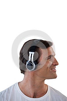 Smiling mature man listening music through headphones