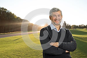 Smiling mature man on nature background.