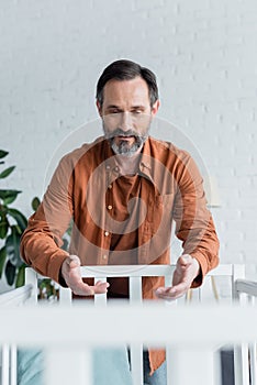 Smiling mature man with outreached hands