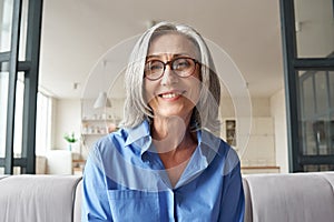 Smiling mature older woman looking at camera, webcam headshot.