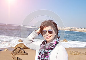 Smiling mature woman of 50 years on the beach