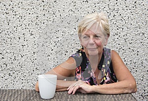 Smiling mature woman with coffee with copy space