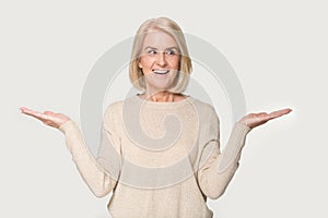 Smiling mature woman compare options considering pros and cons