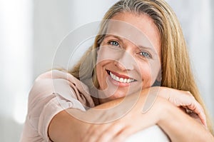 Smiling mature woman on couch