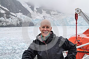 Smiling mature woman, cruise glaciers icebergs photo