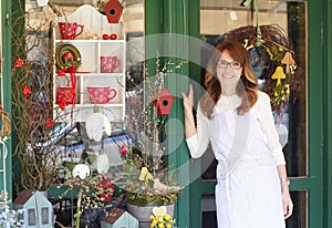 Smiling Mature Woman Florist At Flower Shop