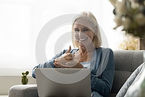 Mature woman with hearing impairment take part in virtual meeting photo