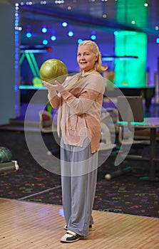 Smiling Mature Woman Playing Bowling