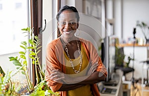 Smiling mature woman standing in her apartment