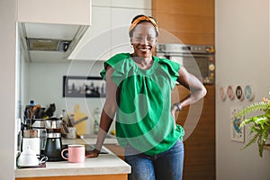 Smiling mature woman standing in her kitchen