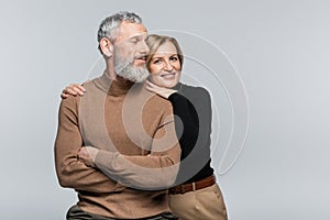 Smiling mature woman in turtleneck hugging