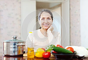 Smiling mature woman with vegetables