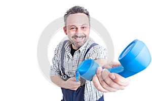 Smiling mechanic giving a blue telephone receiver